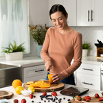 A woman chopping ingredients next to the Etekcity Luminary™ Kitchen Scale