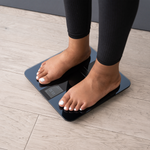 Feet standing on the Etekcity HR Smart Fitness Scale