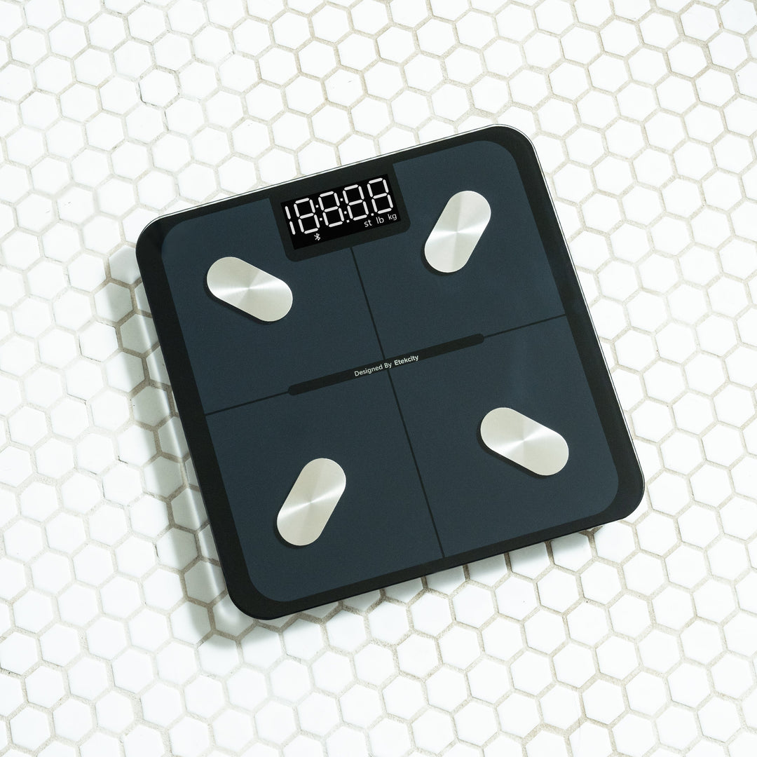 Etekcity Smart Fitness Scale on honeycomb-patterned tile floor.