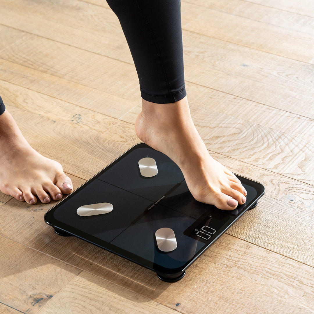 A foot stepping on the Etekcity Smart Fitness Scale 