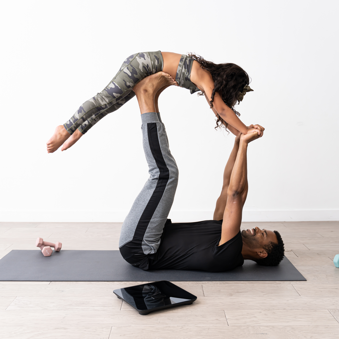 A couple doing yoga next to the Etekcity HR Smart Fitness Scale 